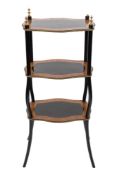 A French ebonised, crossbanded and inlaid three tier etagere:, of serpentine outline,