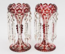 A pair of ruby flashed table lustres: of typical coronet form with slice cut and annulated stem and