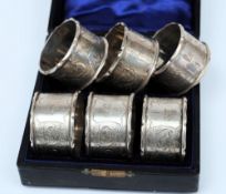 A cased set of six Edward VII silver napkin rings, maker Williams Limited, Birmingham 1901,