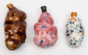Two Staffordshire pottery 'potato' flasks and one other: one under pale puce glazes with blue