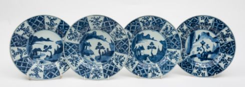 A matched set of four Chinese blue and white plates: each painted in the centre with a building,