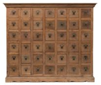 A 19th Century apothecary's teak dispensing chest:, with a moulded cornice,