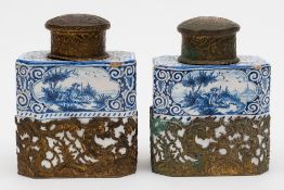 A pair of Dutch Delft tea canisters: of canted rectangular form,