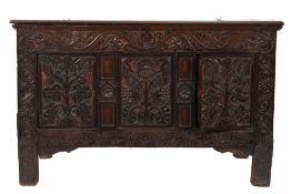 An early 18th Century carved oak coffer:, with a plain hinged moulded top,
