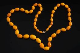 A graduated amber bead single string necklace: with 47 oblong beads, the largest bead 20.