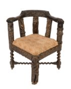 An antique carved oak corner elbow chair:,