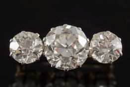 A diamond mounted three-stone bar brooch: the central diamond approximately 9.85mm x 6.