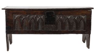 An early 18th Century oak rectangular coffer:, of plank construction with a hinged moulded top,