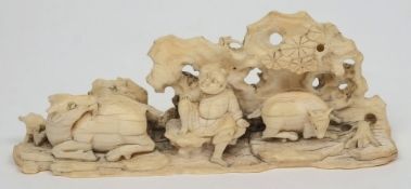 A Chinese carved ivory figure group: of a farmer seated below a tree with cattle, 8.5cm.