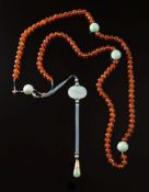 A Chinese Mandarin's Court amber and jadeite necklace: with one hundred and eight amber beads