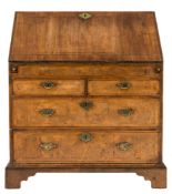 An early 18th century cross and feather banded walnut bureau:,
