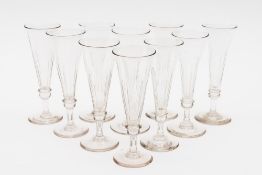 Ten champagne flutes: each with slice cut trumpet shaped bowls with basal annular ring on a short