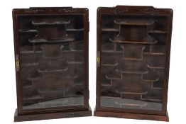 A pair of Chinese hardwood wall mounted display cabinets:, of rectangular shape and small size,