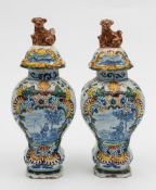 A pair of  Dutch polychrome  Delft jars and covers: of inverted pear shaped form,
