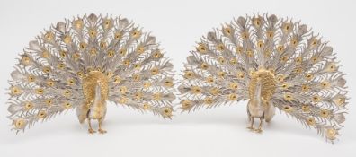 A pair of 20th century Spanish silver gilt models of peacocks: both in full display, 29cm. wide, 20.