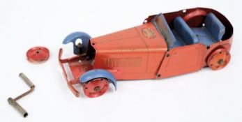 A Meccano clockwork open salon:, red body and chassis with blue mud guards and seats, incomplete.