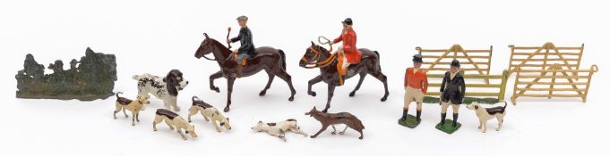 A Britains hunting group:, comprising two riders on horseback, two standing huntsmen,