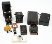 A Cornet Midget Bakelite camera, two other miniature cameras,