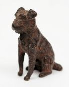 A cold painted bronze of a seated Terrier:, 4.5cm high.
