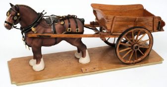 A Beswick model of a Shire horse mounted with a scale model of a hay cart on a wooden plinth:,