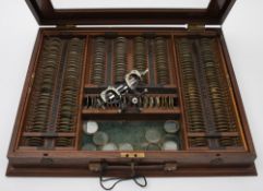 A mahogany and glazed case of optician's lenses and glasses, Curry & Paxton, London:,
