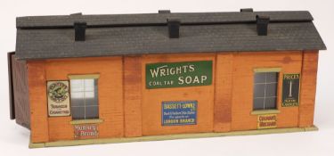 A Bassett-Lowke engine shed: with applied tinplate advertising signs to the side walls, 48.5cm.