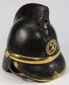 An Edwardian leather Merryweather pattern Fireman's helmet: with brass crossed axe badge,