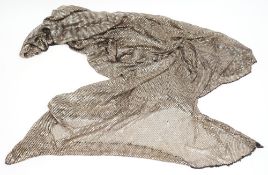 An Art Deco period Turkish silver shawl:, with fine mesh on a black ground, some tears and holes.