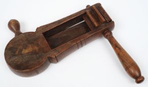 A 19th century treen bird scarer:, in the style of a rattle with turned handles 26cm long..