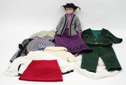 A Victorian style wax shoulder headed doll and a small quantity of various costumes:, applied hair,