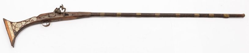 A 19th Century Afghan Jezail:, with 102cm barrel flared at the muzzle, full wood stock,