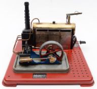 Mamod, a live steam plant:, with horizontal boiler and twin pistons driving a single fly wheel,
