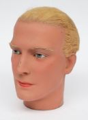 An early 20th century male wax mannequin head:,  with real hair, glass eyes and painted face,