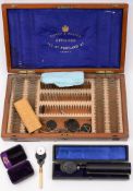 A late 19th/early 20th Century mahogany cased set of optician's lenses for Curry and Paxton,