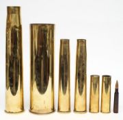 Seven brass shell cases: various calibres and dates.