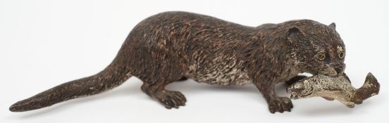 An Austrian cold painted bronze figure of an otter:, holding a fish in its mouth,