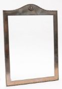 An Eastern white metal photograph frame with armorial crest decoration:, lacks backing board,