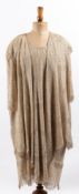 An early 20th century  white crochet and gilt thread cocktail dress and jacket displayed on a