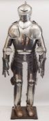 A 20th century suit of armour together with a wax male mannequin head inset glass eyes:,