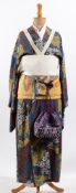 An early 20th century Japanese kimono, on a period mannequin,