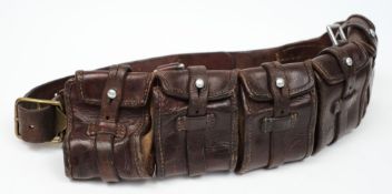 A Boer War period leather bandolier:, with 5 strap and button cartridge pouches,