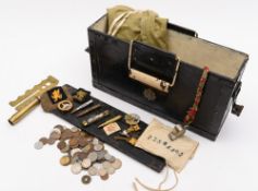 A collection of militaria: to include cloth insignia, cap badges, buttons, various coins,
