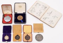 A silver Royal Life Saving Society medal and two bronze life saving medals,