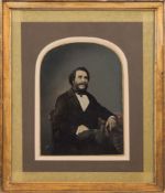 A 19th century whole plate ambrotype of a seated gentleman:, hand tinted in a giltwood frame,