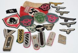 A collection of Third Reich period shoulder boards, badges and totes:, various regiments.