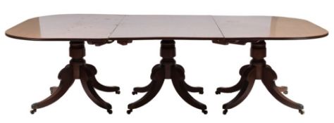 A Regency mahogany three pillar D end dining table:, the top with a reeded edge,