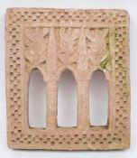A North Indian carved stone plaque:, with pierced arch decoration, enclosed by a chequered border,