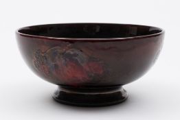 A Moorcroft pottery flambé bowl: of circular form tubelined in the Blackberry and Leaf pattern in