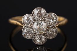 An early 20th century gold, platinum and diamond circular cluster ring:,