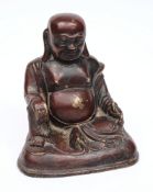A South-East Asian bronze figure of Buddha:, seated with red lacquered patination, 16.5 cm high.
